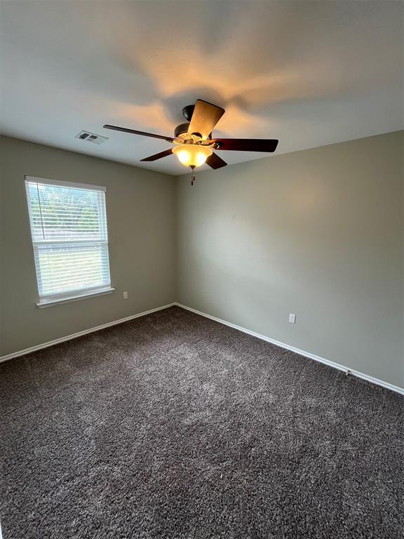 unfurnished room with carpet flooring and ceiling fan