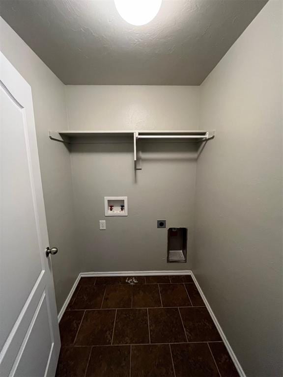 washroom with hookup for an electric dryer, washer hookup, and dark tile patterned floors