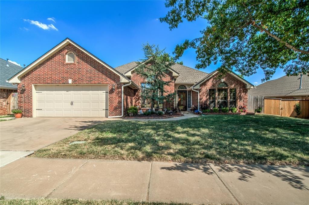 view of front of house with a front yard and a garage