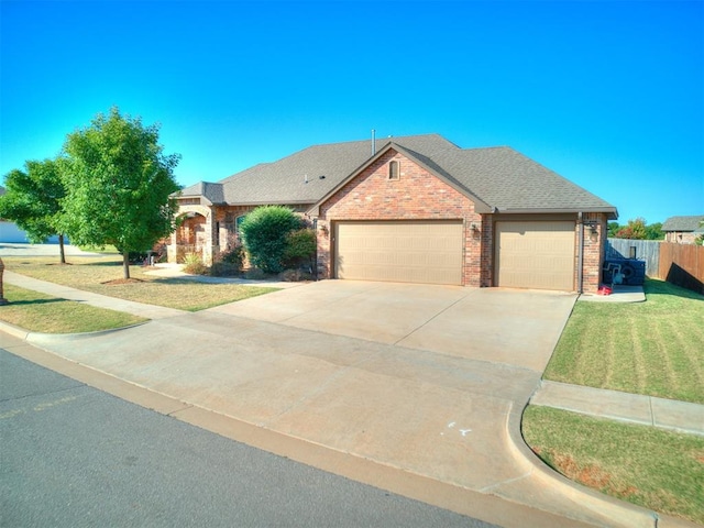 view of front of house featuring a front lawn and a garage