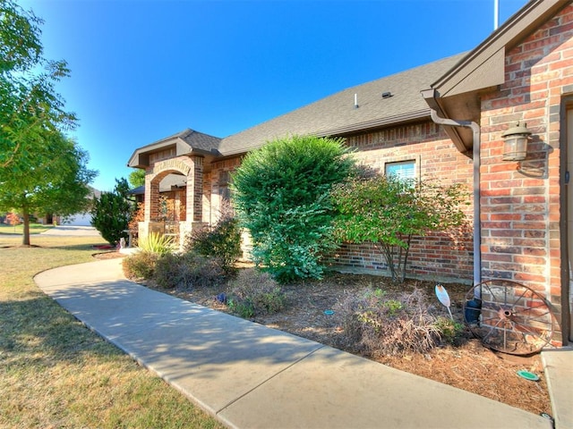 view of exterior entry with a yard