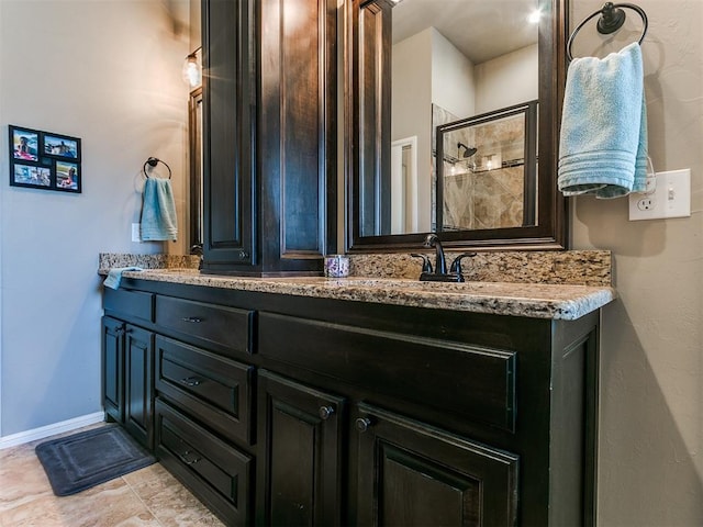 bathroom featuring a shower and vanity