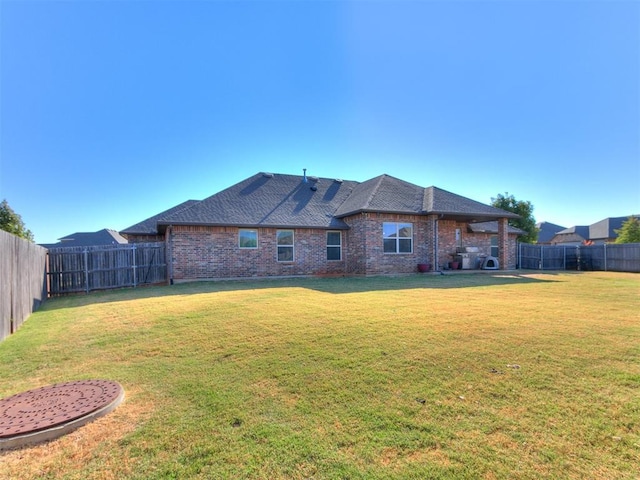 rear view of house with a lawn