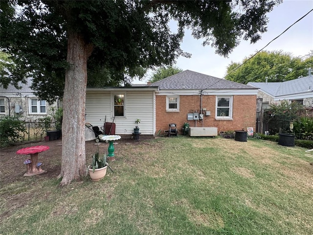 rear view of property with a yard