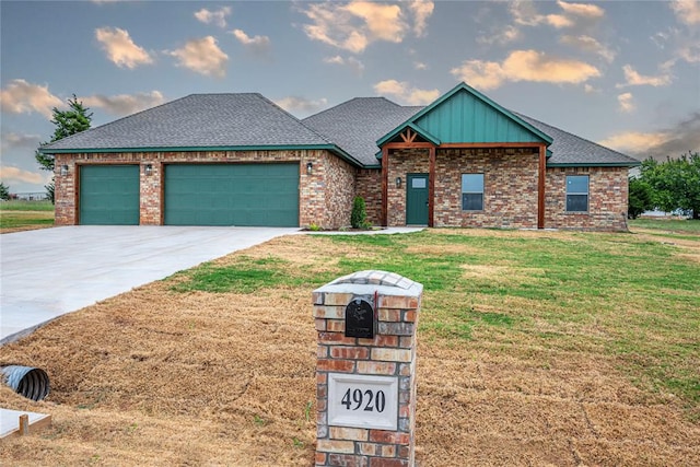 view of front of property featuring a garage and a front lawn