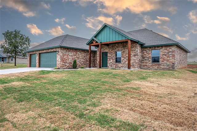 view of front of home featuring a garage and a front lawn