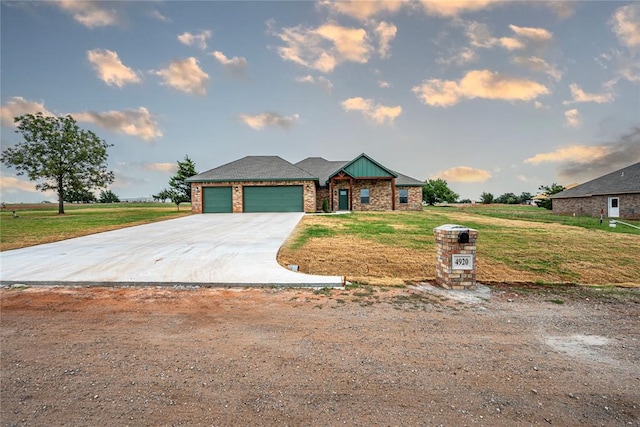 view of front of house with a garage and a front lawn