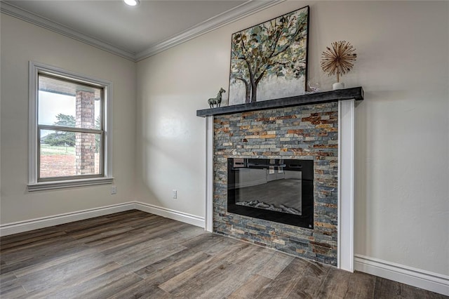 unfurnished living room with hardwood / wood-style floors, a stone fireplace, and ornamental molding