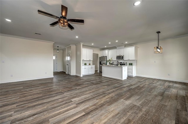 unfurnished living room featuring ceiling fan, dark hardwood / wood-style floors, and ornamental molding