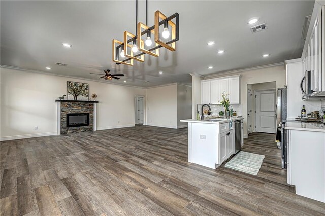 kitchen featuring white cabinets, ceiling fan, dark hardwood / wood-style floors, decorative light fixtures, and stainless steel appliances