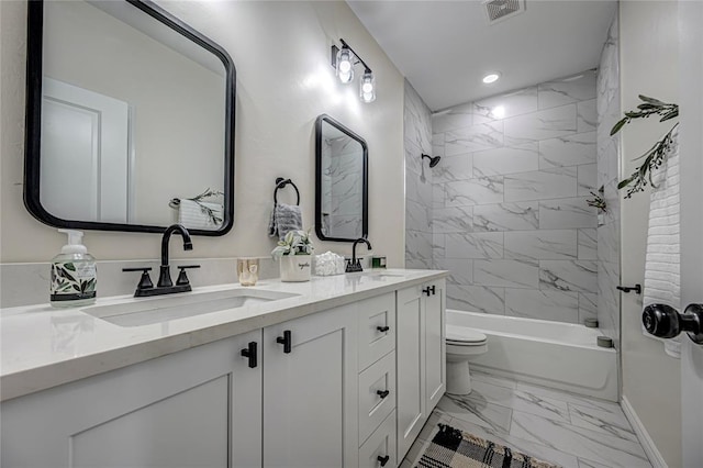 full bathroom with vanity, toilet, and tiled shower / bath