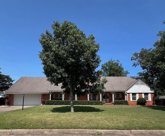 ranch-style home with a front lawn and a garage