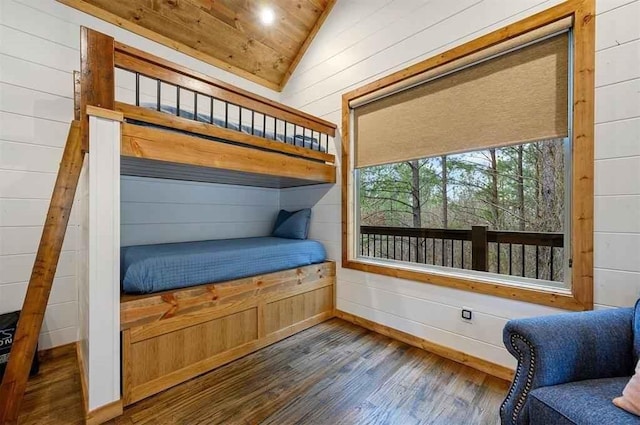 bedroom featuring dark hardwood / wood-style flooring, wood ceiling, wooden walls, and vaulted ceiling