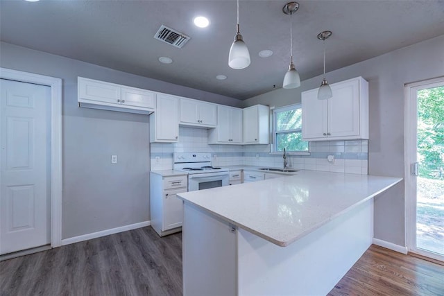 kitchen featuring white cabinetry, white electric range, and a wealth of natural light