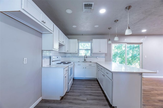 kitchen with white range with electric stovetop, dark wood-type flooring, sink, white cabinets, and hanging light fixtures