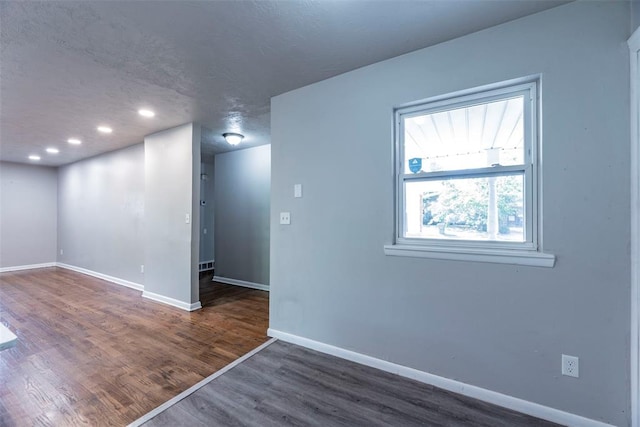 empty room with dark wood-type flooring