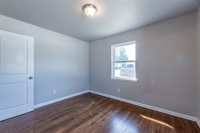 empty room with dark hardwood / wood-style floors