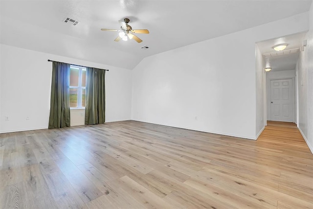 spare room with ceiling fan, light hardwood / wood-style floors, and lofted ceiling