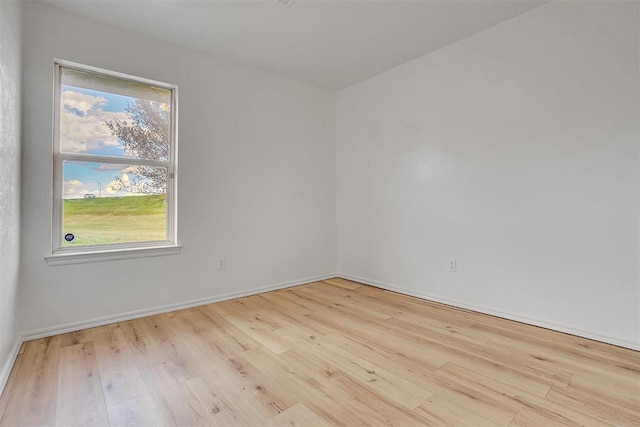 spare room with light hardwood / wood-style flooring