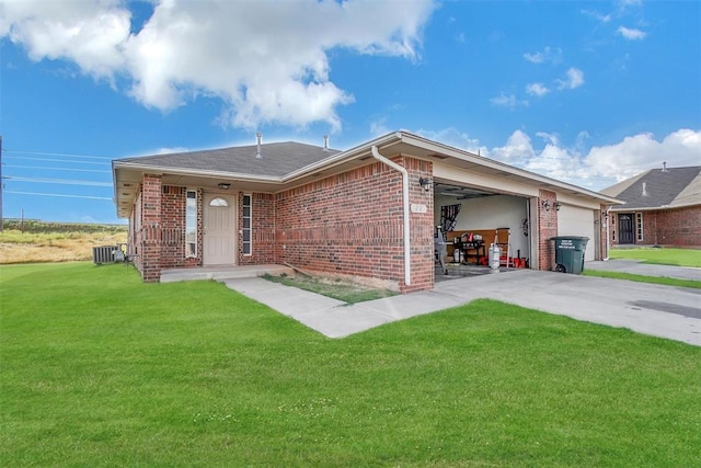 ranch-style house featuring cooling unit, a front yard, and a garage