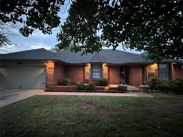 view of front of home with a garage and a front lawn