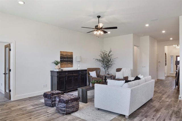 living room featuring ceiling fan and wood-type flooring