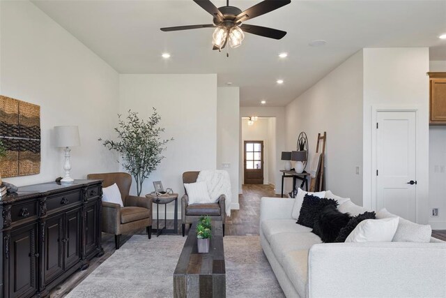 living room featuring hardwood / wood-style floors and ceiling fan