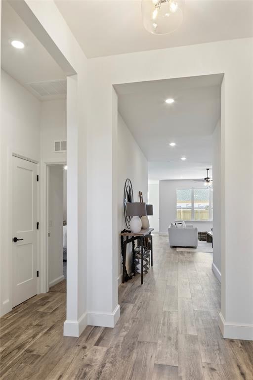 corridor with light hardwood / wood-style floors