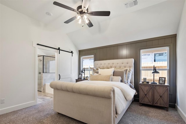 carpeted bedroom with a barn door, ceiling fan, multiple windows, and lofted ceiling