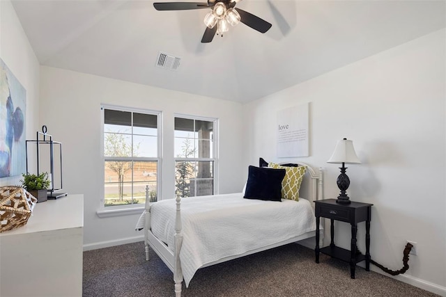 bedroom featuring vaulted ceiling, dark carpet, and ceiling fan