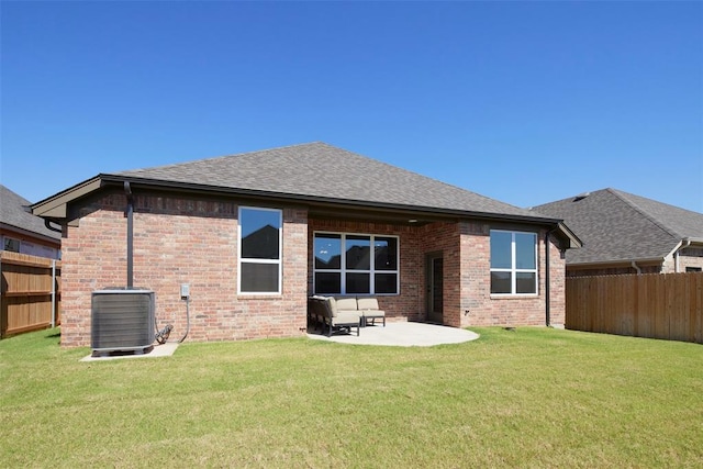 back of property featuring a patio, central AC unit, and a lawn