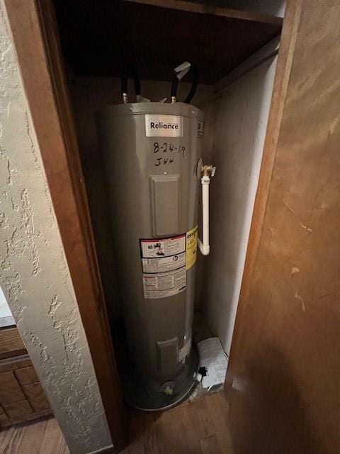 utility room with electric water heater