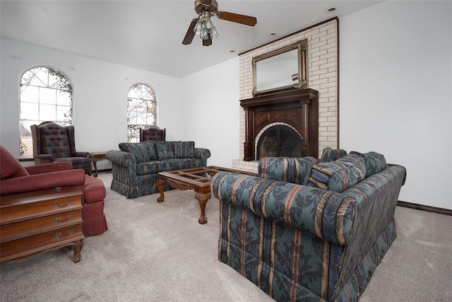 living room featuring ceiling fan, light colored carpet, and a brick fireplace