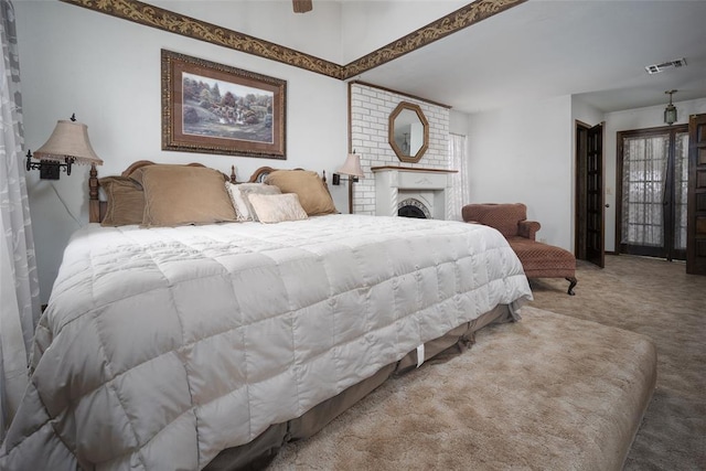 bedroom featuring a fireplace, ceiling fan, and carpet flooring