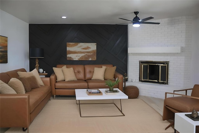 living room with ceiling fan and a brick fireplace