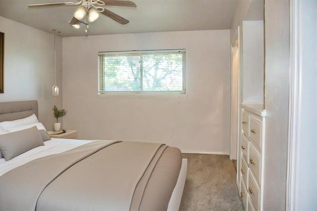 bedroom with ceiling fan and light colored carpet