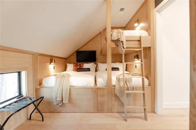 interior space featuring light wood-type flooring and lofted ceiling