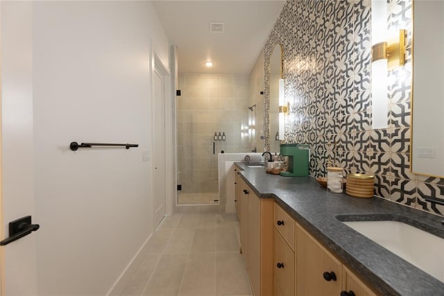 bathroom with tile patterned floors, vanity, and an enclosed shower