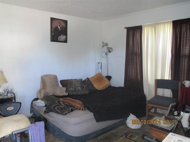 carpeted bedroom featuring a textured ceiling