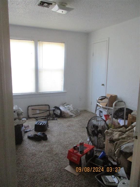 carpeted bedroom featuring a textured ceiling