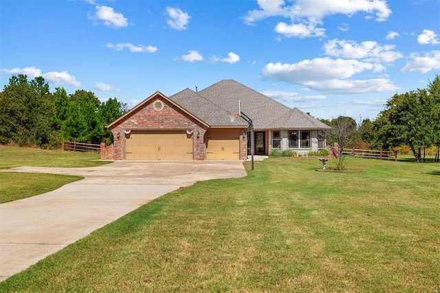 view of front of house with a garage and a front lawn