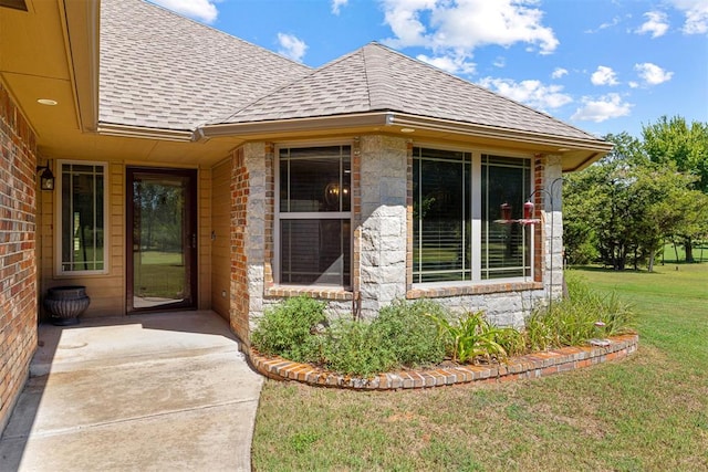 doorway to property featuring a lawn