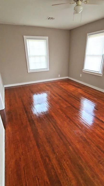 spare room with ceiling fan and hardwood / wood-style flooring