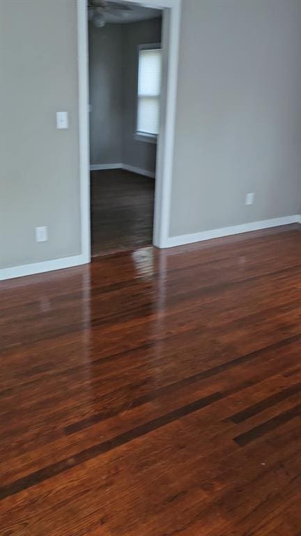 empty room with dark hardwood / wood-style floors