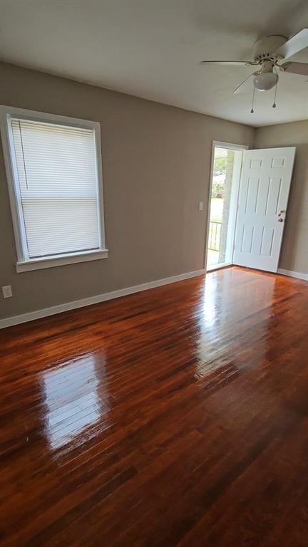 interior space with ceiling fan and dark wood-type flooring