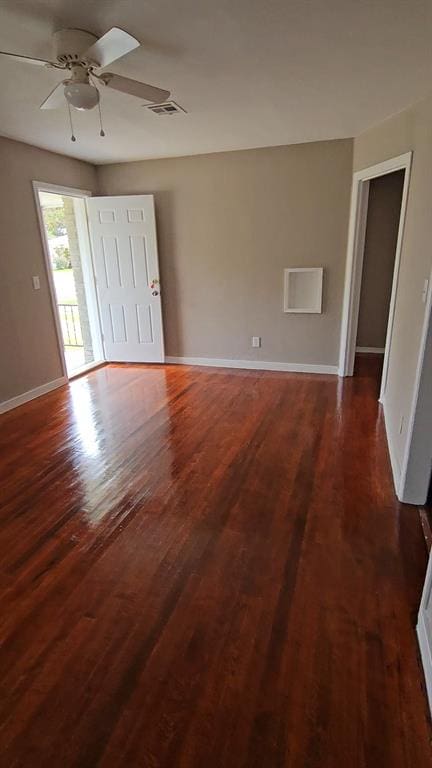 unfurnished room with ceiling fan and dark hardwood / wood-style flooring