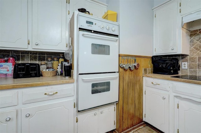 kitchen featuring white double oven and white cabinetry