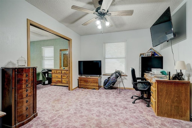 carpeted office featuring ceiling fan and a textured ceiling