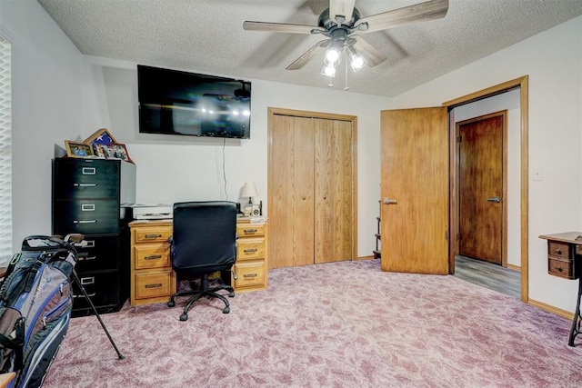 office area featuring ceiling fan, a textured ceiling, and light carpet