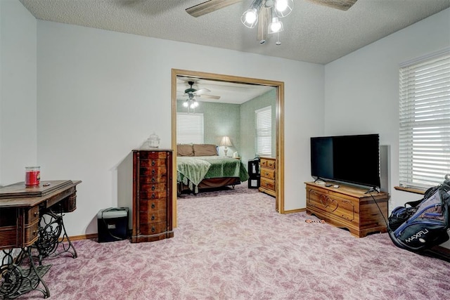 carpeted bedroom with ceiling fan and a textured ceiling